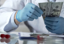 Confessions of an Advertising Writer: How I Helped Pharma Sell Antidepressants Closeup of a researcher's blue-gloved hands counting money