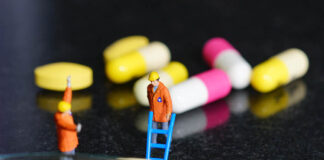 Antidepressant Trials Last Eight Weeks, So Why Do We Take Them for Years? Miniature people - The worker at work with medicine pills