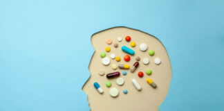 Researchers: “We Do Not Suggest” Antipsychotics for Depression A cutout of a head as if made of blue paper. The head is full of pills.