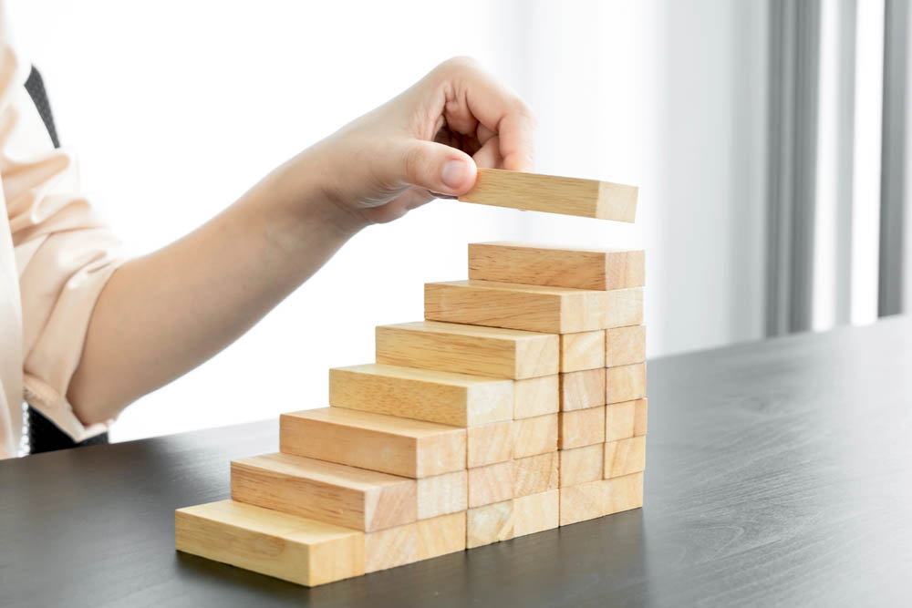 Stacking wooden blocks upward like stairs