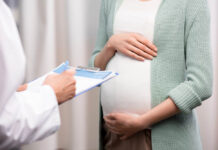 Pregnant person consulting a doctor