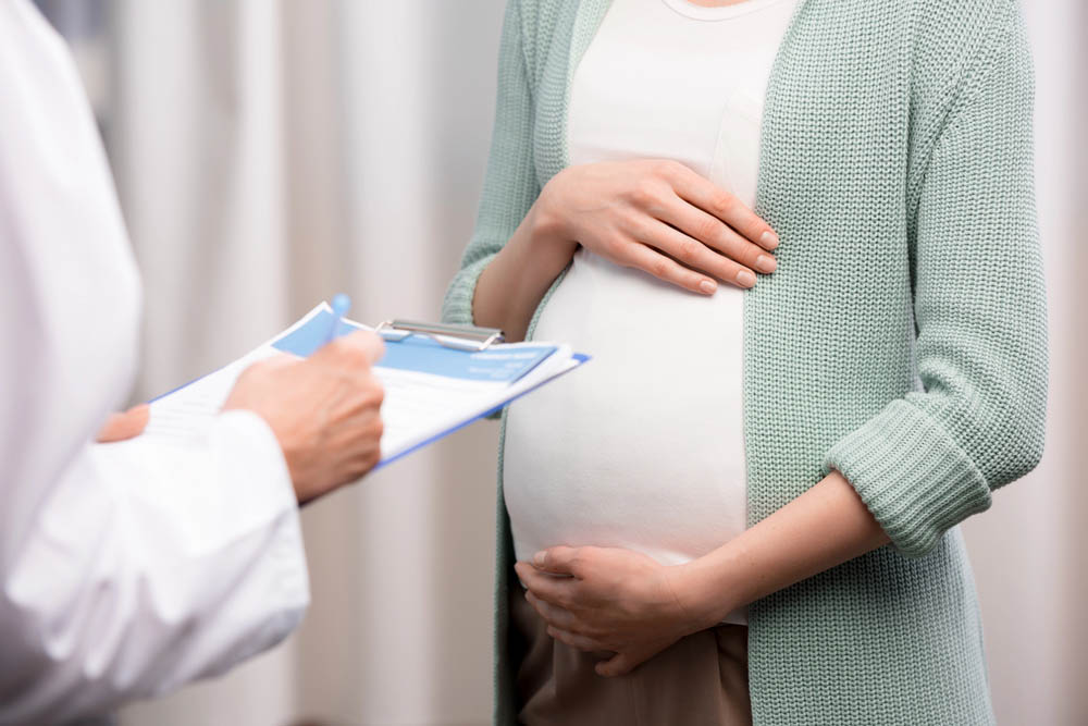 Pregnant person consulting a doctor
