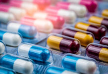 Selective focus on blue-white capsule pills in blister pack