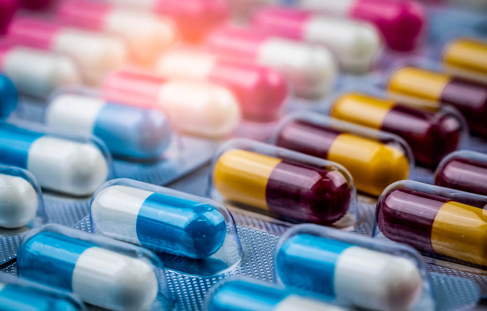 Selective focus on blue-white capsule pills in blister pack