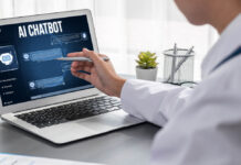 A woman wearing white in the medical field looks at an AI chatbot on a laptop computer