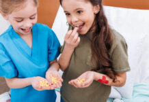 A couple of kids chowing down on some little pills