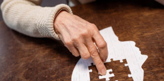 “I Can’t Remember a Single Day”: New Survey Shows Disastrous Memory Effects of ECT An elderly person's hand pushes a puzzle piece into a flat empty head shape