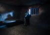 Fifty Years of Grief Miniature photography. Lonely man bathed in moonlight in a prison cell