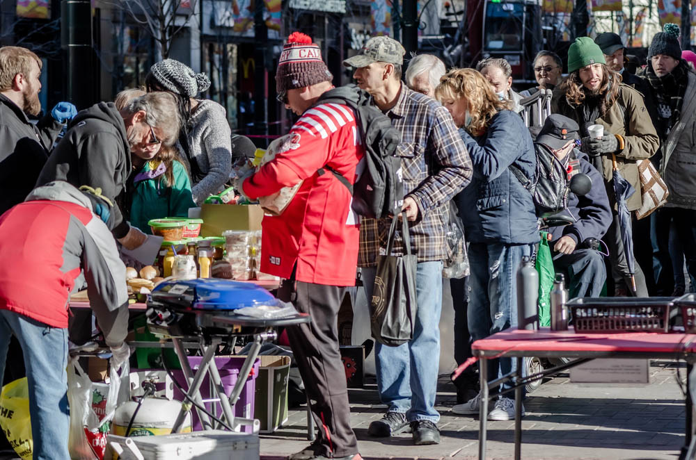 Calgary, Alberta, Canada - November 6, 2021: A small group of people providing a meal to the homeless and any other people in need in downtown Calgary