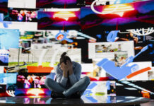 Short-Form Video Linked to Worse Cognitive and Mental Health Young man stares at smartphone in distress symbolizing toxic impact of social media on mental health. Likes, posts and endless scrolling lead to stress, anxiety and depression. Overwhelmed user.