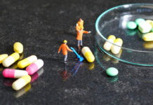 Antidepressant “Maintenance Treatment” Not Required: Slow Tapering with Support Works Miniature people - The worker at work with medicine pills