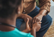 Beyond Pleasure: A Developmental View of Addiction Female healthcare worker holding hands of senior man at care home, focus on hands. Doctor helping old patient with Alzheimer's disease. Female carer holding hands of senior man