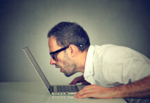 Case Studies Contradict Accepted Wisdom About AI Psychosis Side profile man staring closely intensely at laptop screen