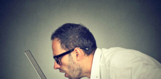 Case Studies Contradict Accepted Wisdom About AI Psychosis Side profile man staring closely intensely at laptop screen
