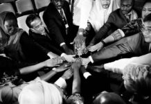Winning Mad Liberation with a New Strategy: Solidarity Diverse people placing hands together in solidarity