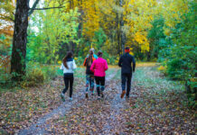 Exercise for Depression: As Good as Therapy or Antidepressants Running people. Adult athletes run along path park, an active way of life fall nature. Running athletes park run early morning. Several children are running woods doing sports. Healthy lifestyle.