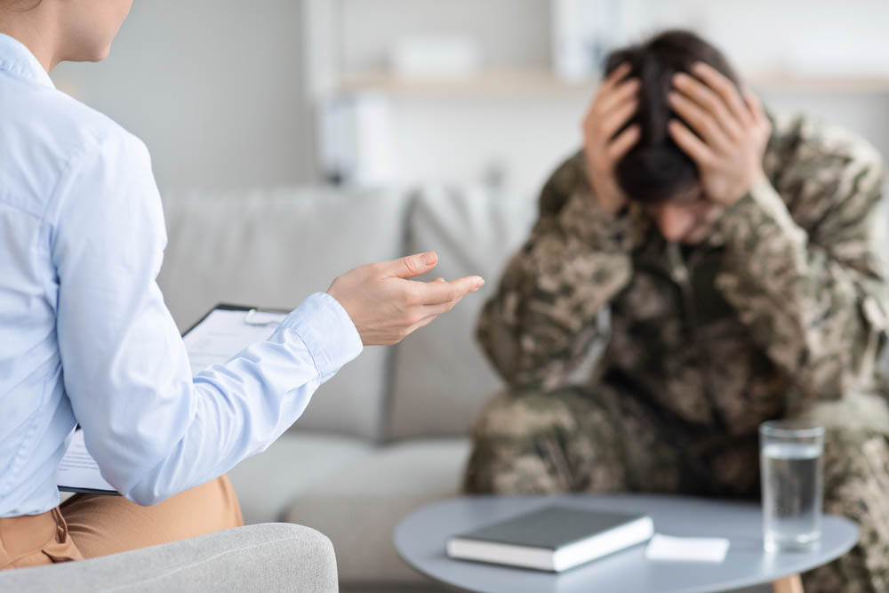 psychologist having conversation with depressed soldier