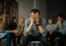 What Frontline Addiction Nurses See That Policy Debates About Medication Miss young caucasian man tired of drinking alcohol or drugs, members of anonymous alcoholics club gathered to share experience of getting rid of problem. guy close face with hands. help, support concept
