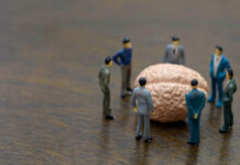 Your Vagus Nerve Is Not in Control: The Problem with Polyvagal Theory Miniature photography; a group of people stand around a brain looking confused
