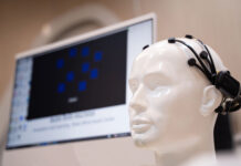 Simulate wearing brain scanning waves, medical equipment In the laboratory with monitors showing reading and brain.