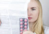Depression Drug Approved by FDA Had 11 Failed Trials and an Advisory Committee Vote Against Approval A blonde white woman reads the product label for drugs in blister pack in her hand
