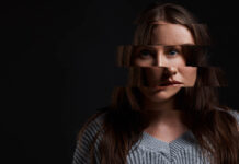 When Treatment Fails: Why I Relate to Lindsay Clancy Studio shot of a woman posing against a dark background with a distorted face.