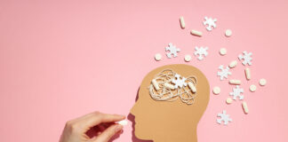 A Call for a Paradigm Shift in Schizophrenia Treatment: Reassessing Long-Term Antipsychotic Use and the Evidence for Psychosocial Interventions Illustration of hand feeding pill to head with puzzle pieces around it