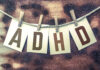 ADHD, a Unicorn in the Psychiatric (Be)wilderness The word "ADHD" stamped on cards and pinned to an old piece of twine over a rusted metal background.