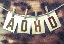 ADHD, a Unicorn in the Psychiatric (Be)wilderness The word "ADHD" stamped on cards and pinned to an old piece of twine over a rusted metal background.